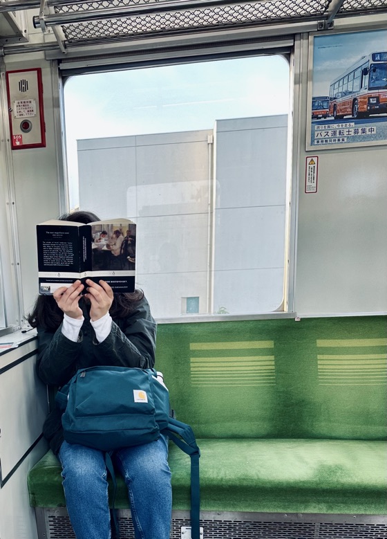 Reading on a train in Japan